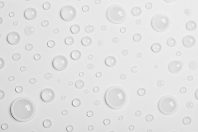 Photo of Water drops on white background, top view