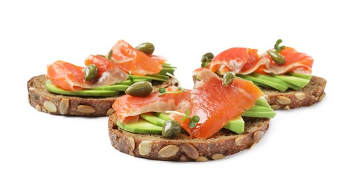 Photo of Delicious sandwiches with salmon, avocado and capers on white background