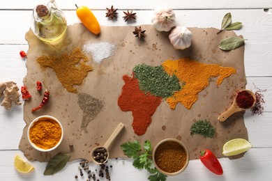 World map of different spices and products on white wooden table, top view