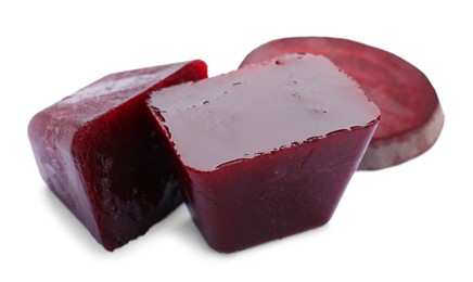 Photo of Frozen beetroot puree cubes and fresh beetroot isolated on white