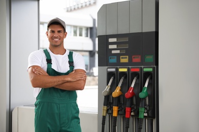 Photo of Worker in uniform at modern gas station