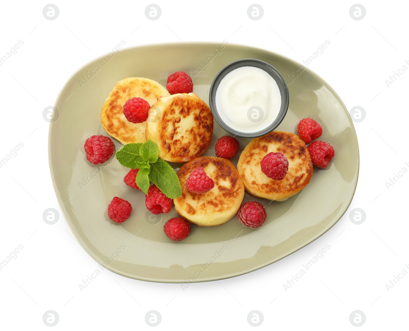 Photo of Plate of delicious cottage cheese pancakes, fresh raspberries, sour cream and mint on white background, top view