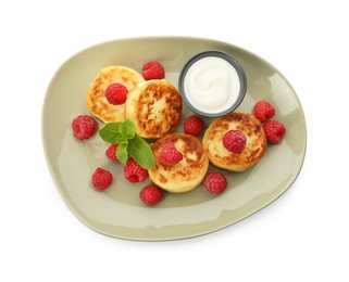 Photo of Plate of delicious cottage cheese pancakes, fresh raspberries, sour cream and mint on white background, top view