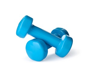 Photo of Light blue dumbbells on white background. Weight training equipment