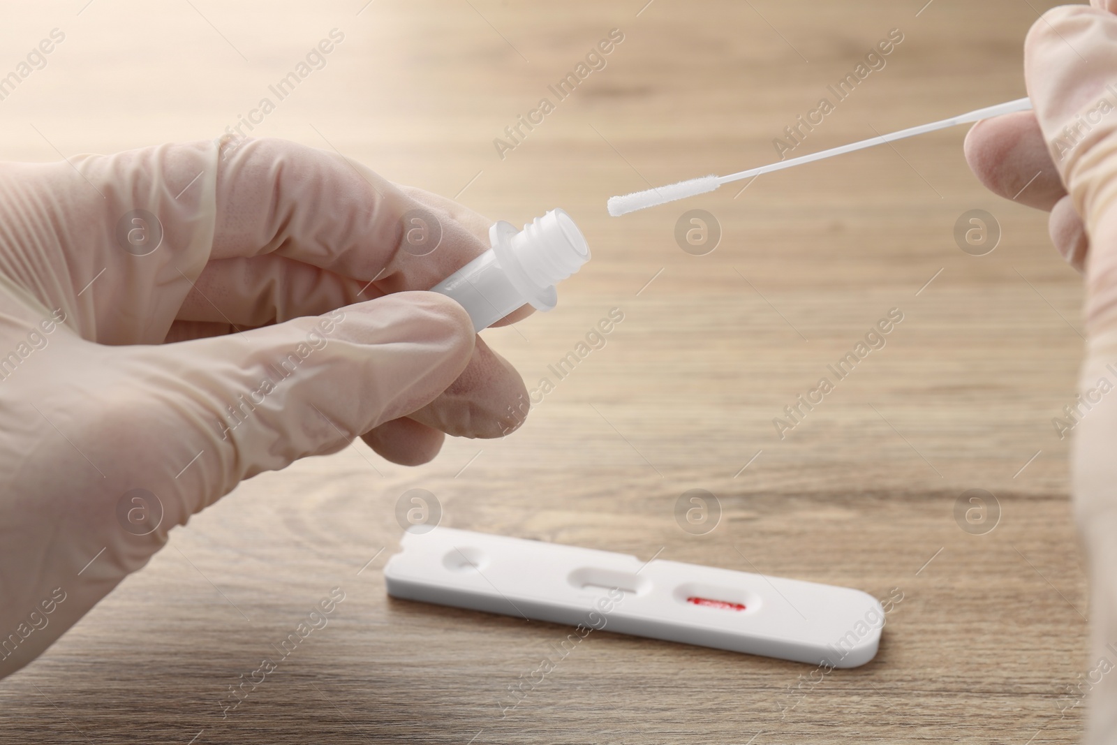 Photo of Doctor making laboratory testing at wooden table, closeup