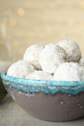 Photo of Tasty snowball cookies in bowl, closeup. Christmas treat