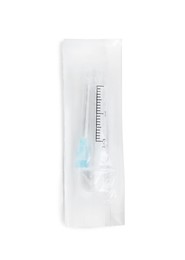 Photo of Packed disposable syringe with needle isolated on white, top view