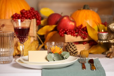 Photo of Beautiful autumn place setting with blank card and decor on table
