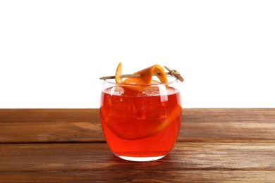 Photo of Aperol spritz cocktail and orange slices in glass on wooden table against white background