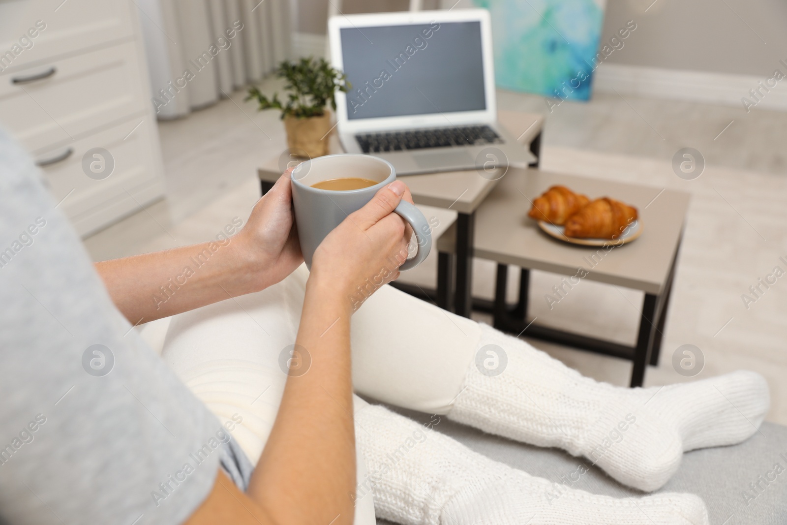 Photo of Woman with cup of coffee resting at home, closeup