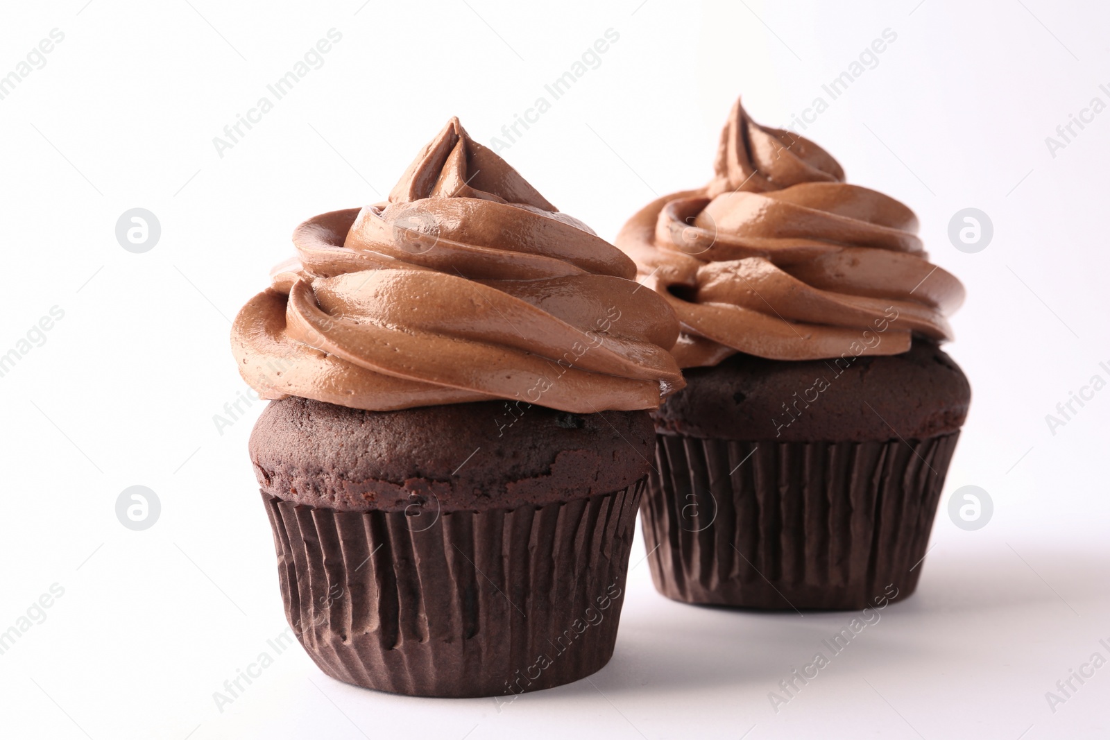 Photo of Delicious chocolate cupcakes with cream isolated on white