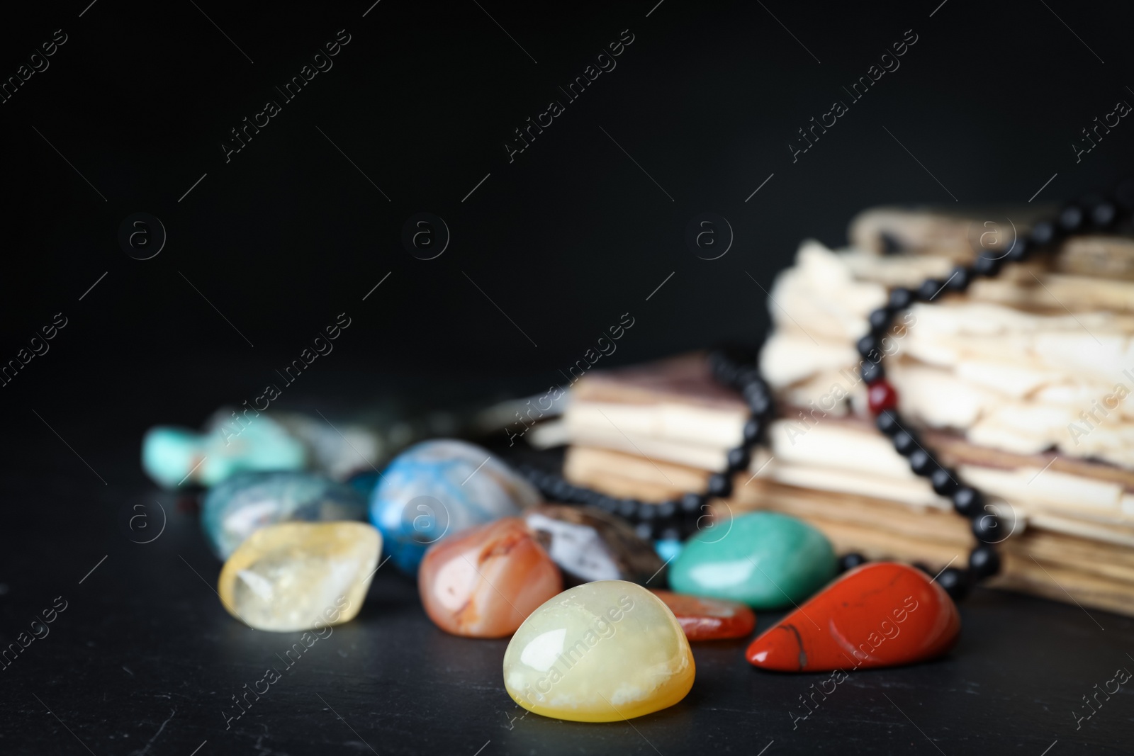 Photo of Different beautiful gemstones on black background