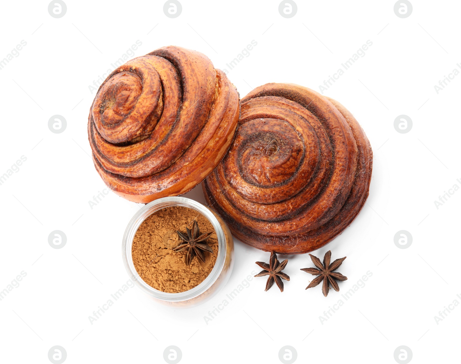 Photo of Freshly baked cinnamon rolls with ingredients on white background, top view