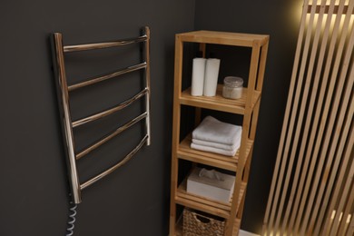 Stylish bathroom interior with heated towel rail and shelving unit