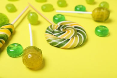 Photo of Many different tasty candies on color background, closeup
