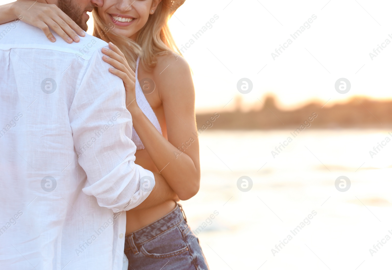 Photo of Young couple spending time together on beach