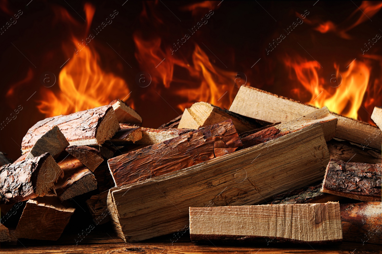 Image of Dry wood and burning fire on background. Cozy atmosphere