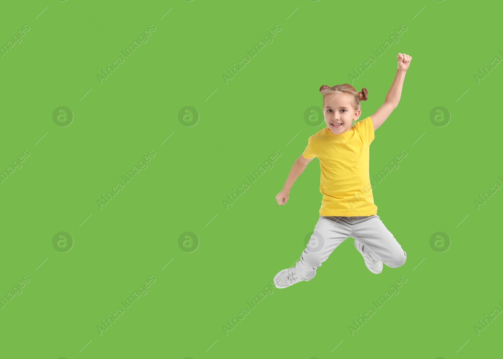 Image of Cute girl jumping on light green background, space for text