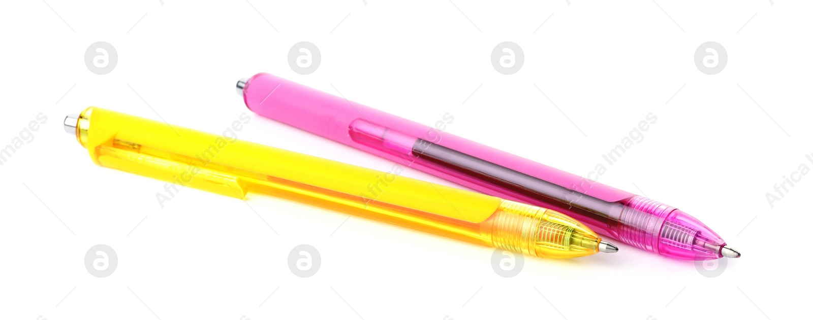 Photo of Pink and yellow retractable pens isolated on white