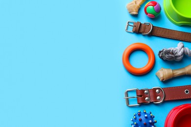 Photo of Flat lay composition with dog collars and different accessories on light blue background, space for text