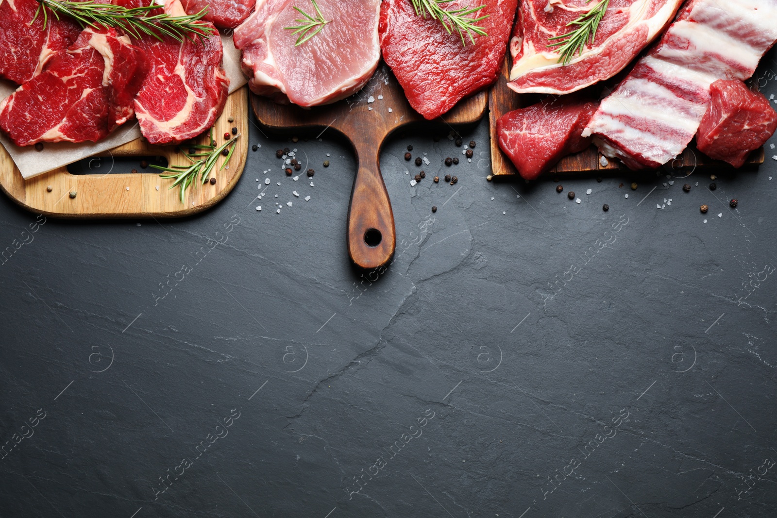 Photo of Flat lay composition with fresh meat on grey table. Space for text