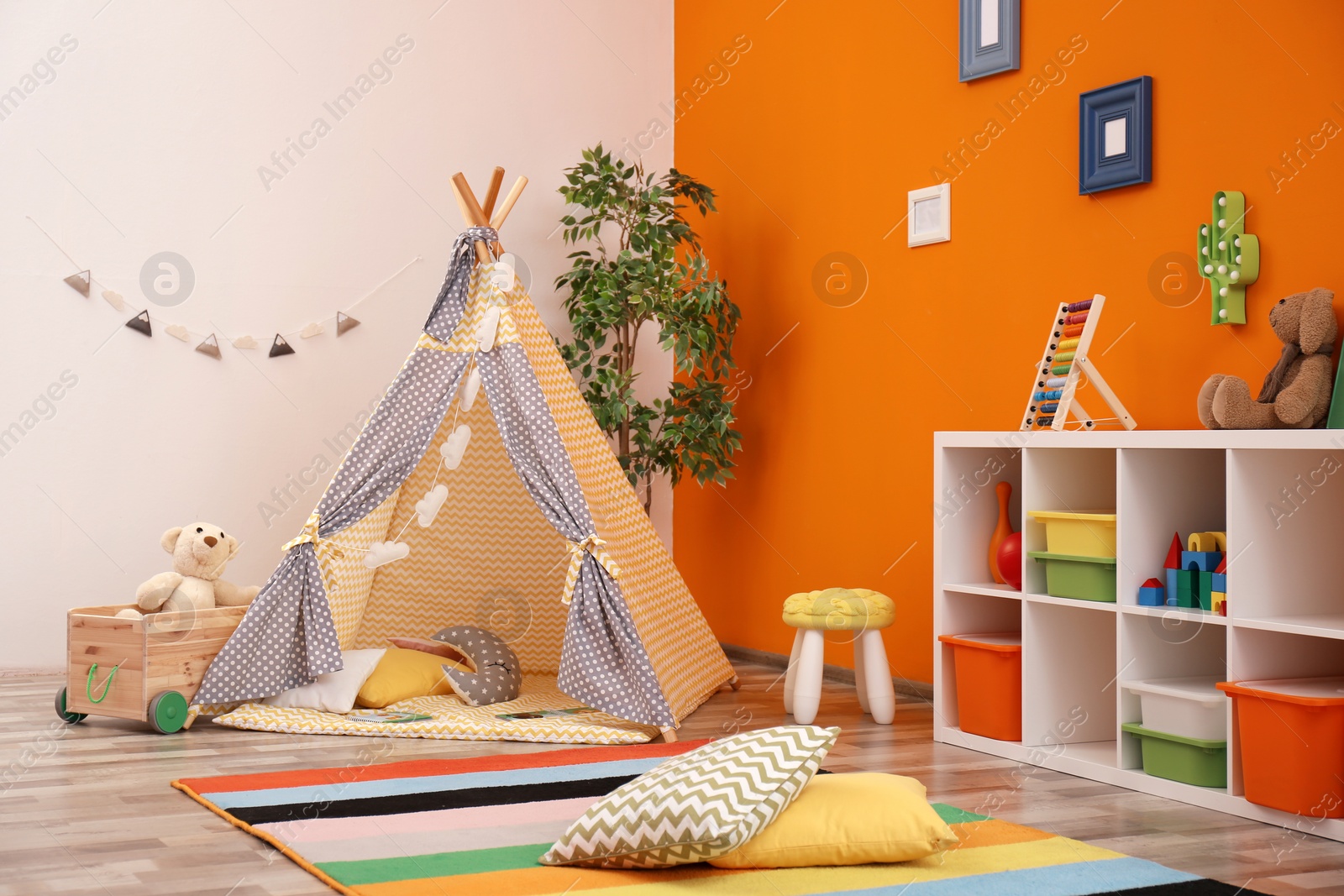 Photo of Cozy kids room interior with play tent and toys