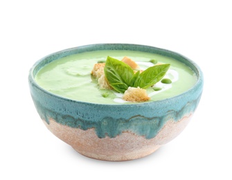 Photo of Green pea soup with croutons in bowl on white background