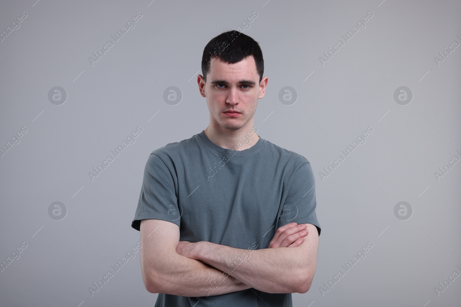 Photo of Portrait of sad man on grey background