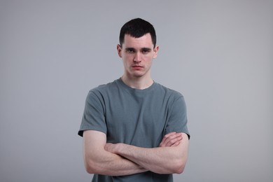 Portrait of sad man on grey background