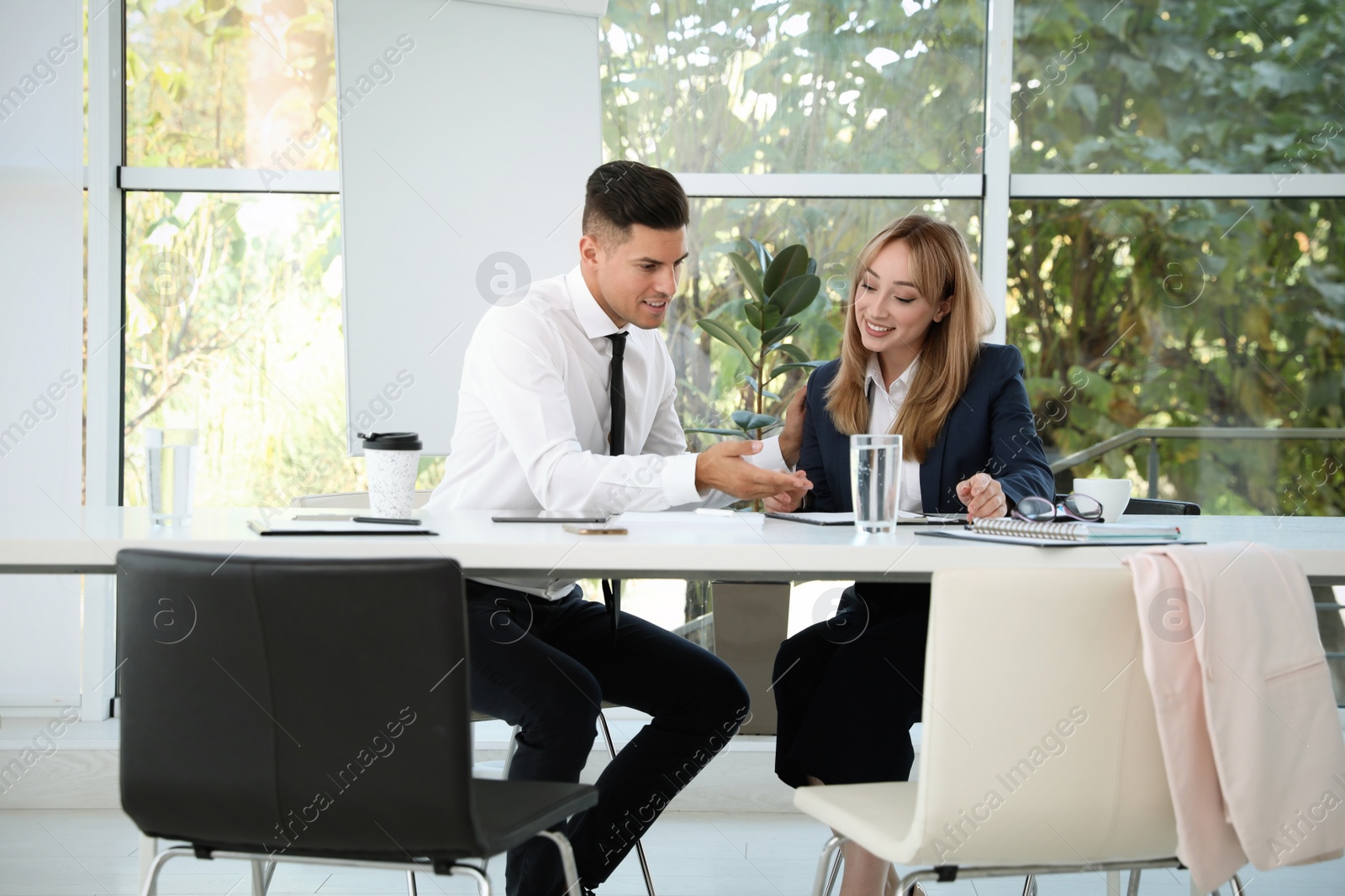 Photo of Office employees talking at table during meeting