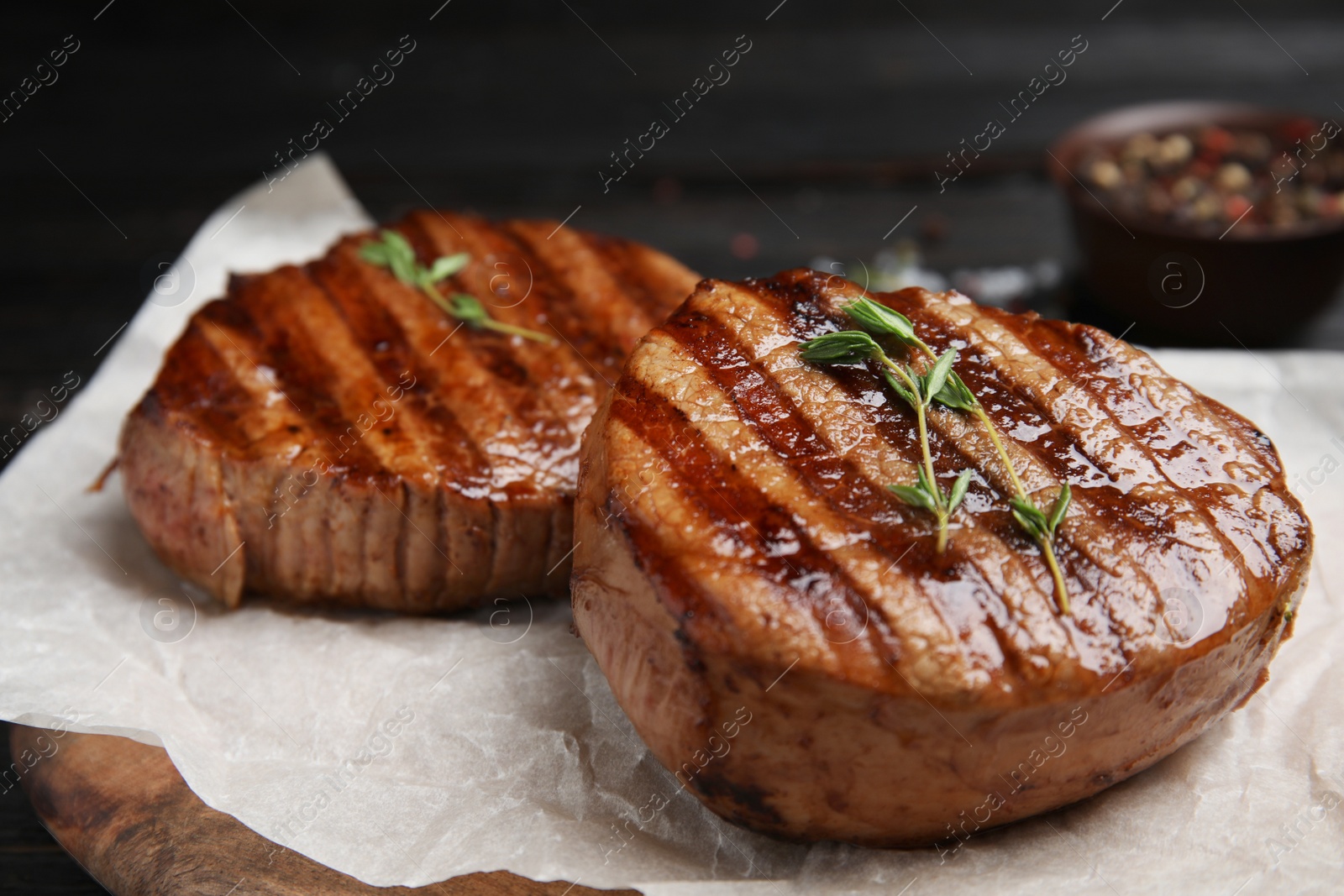 Photo of Delicious grilled beef medallions served on table, closeup