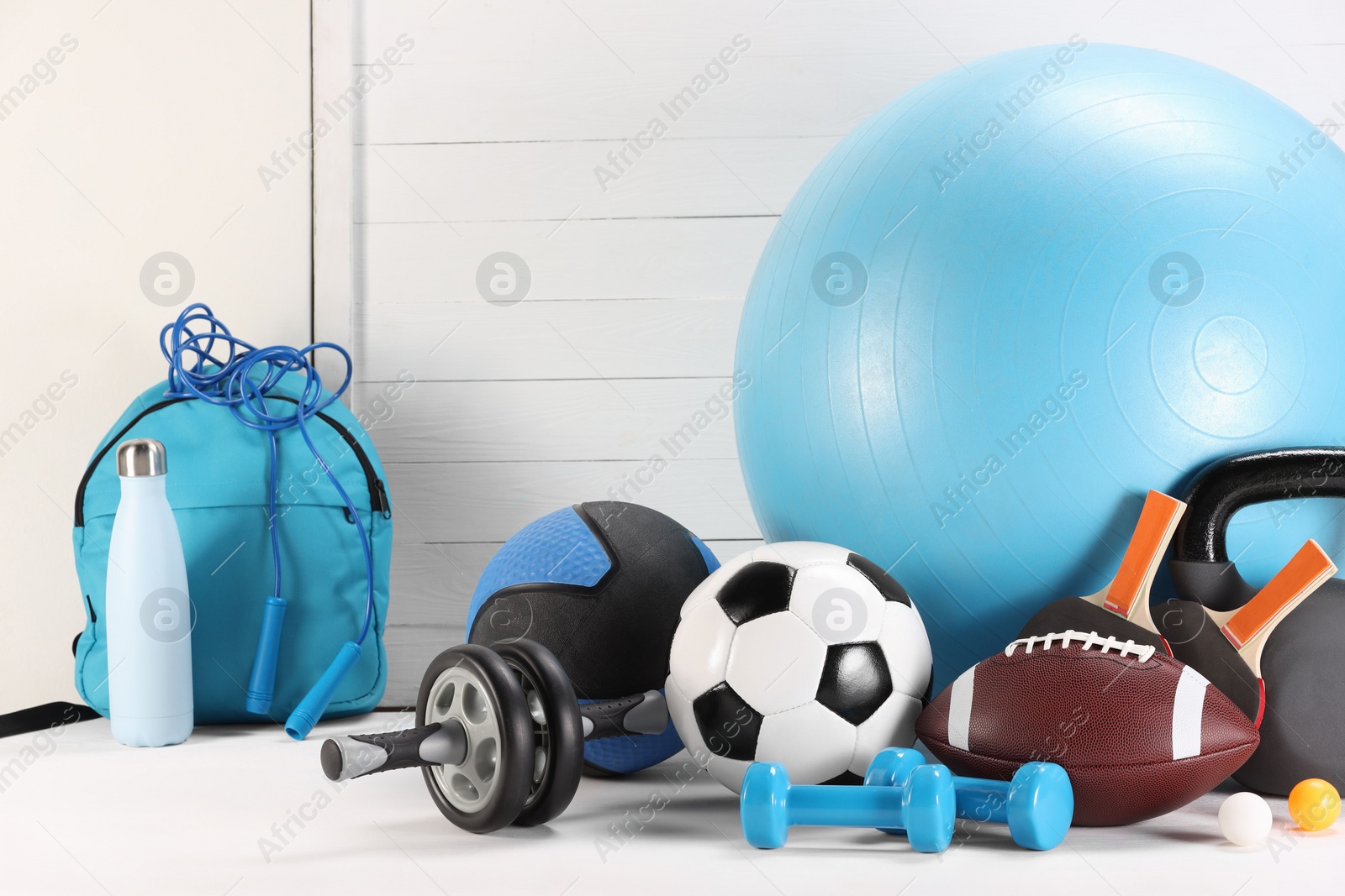 Photo of Many different sports equipment on white table