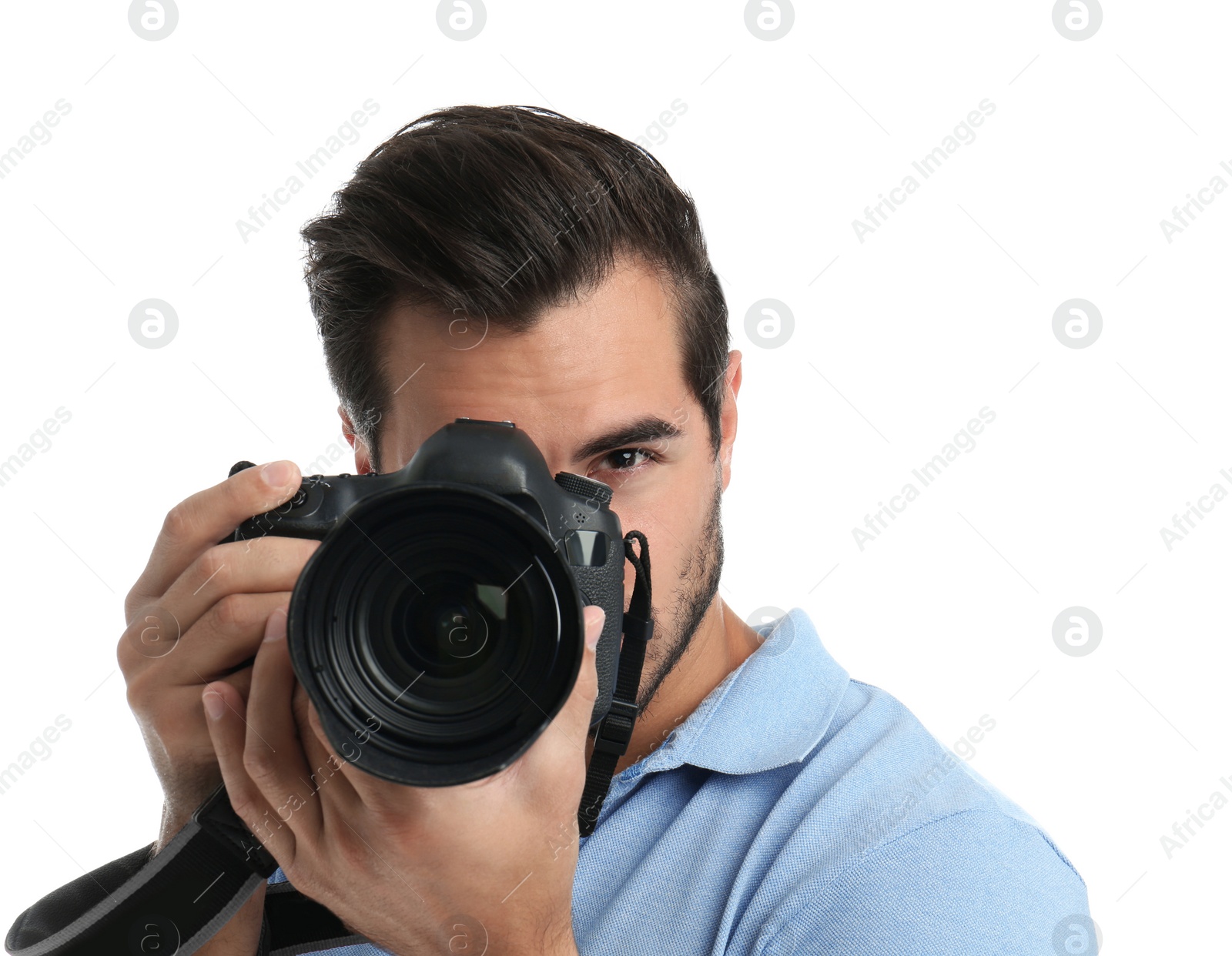 Photo of Young professional photographer taking picture on white background