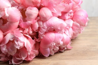 Beautiful pink peonies on wooden table, closeup