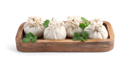 Photo of Tray with uncooked khinkali (dumplings) and parsley isolated on white. Georgian cuisine
