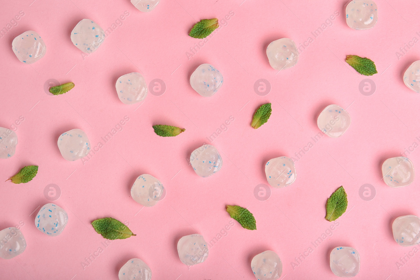 Photo of Flat lay composition with tasty mint candies and leaves on color background