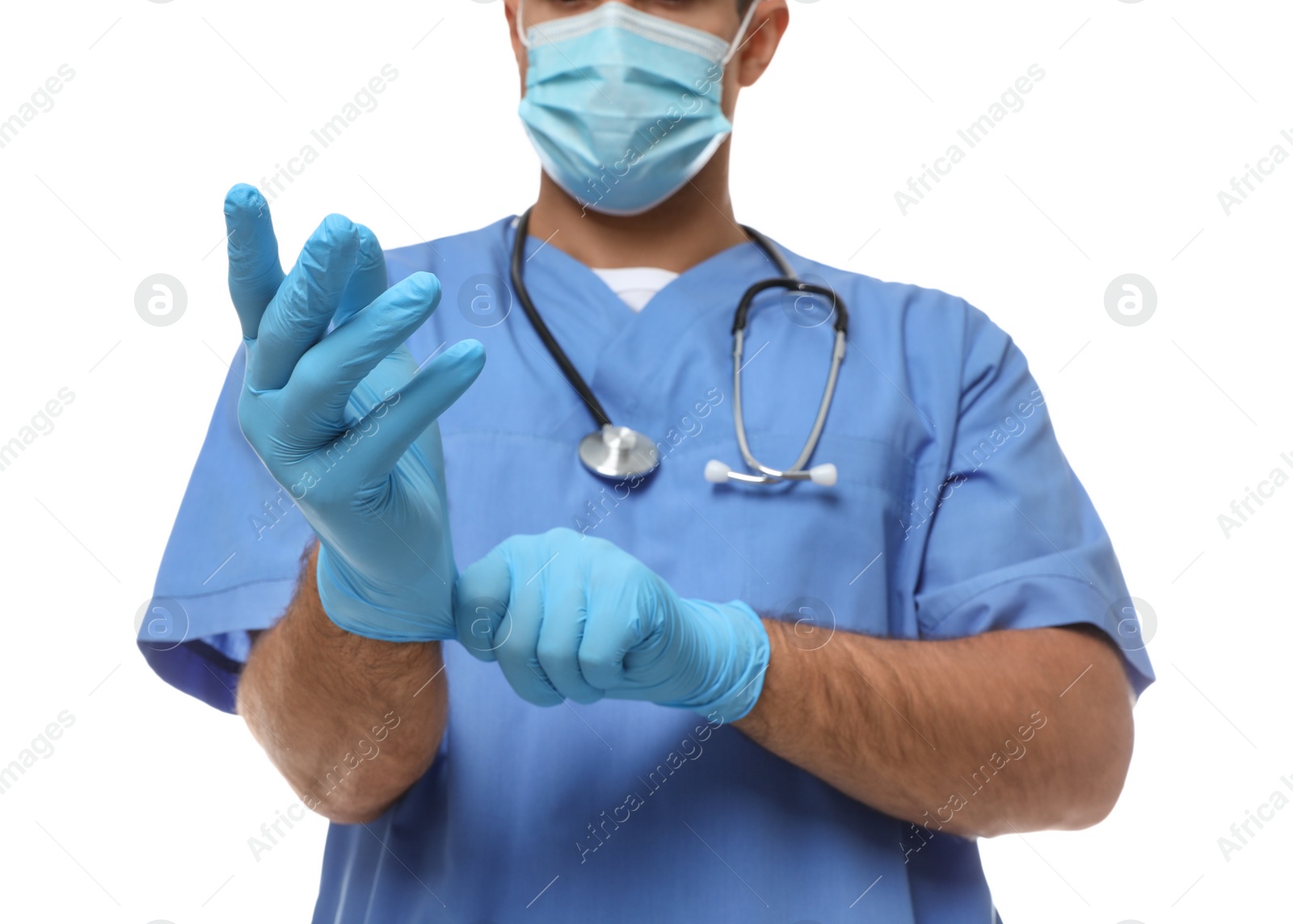 Photo of Doctor in protective mask putting on medical gloves against white background, closeup