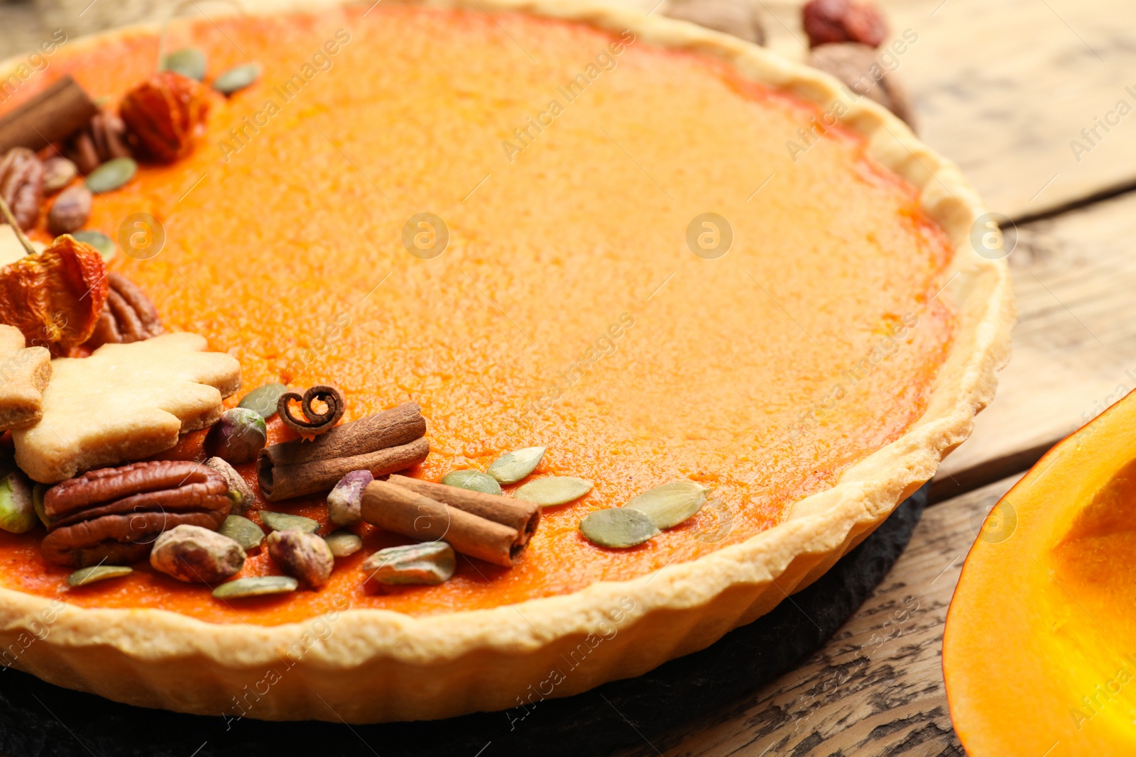 Photo of Delicious homemade pumpkin pie on wooden table, closeup