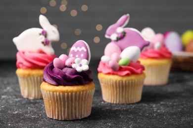 Photo of Tasty decorated Easter cupcakes on grey table