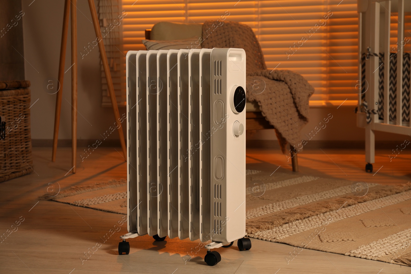 Photo of Modern portable electric heater in child room
