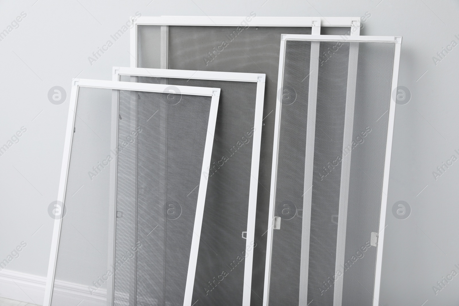 Photo of Set of window screens near light grey wall indoors