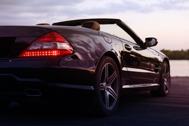 Photo of Luxury black convertible car outdoors in evening