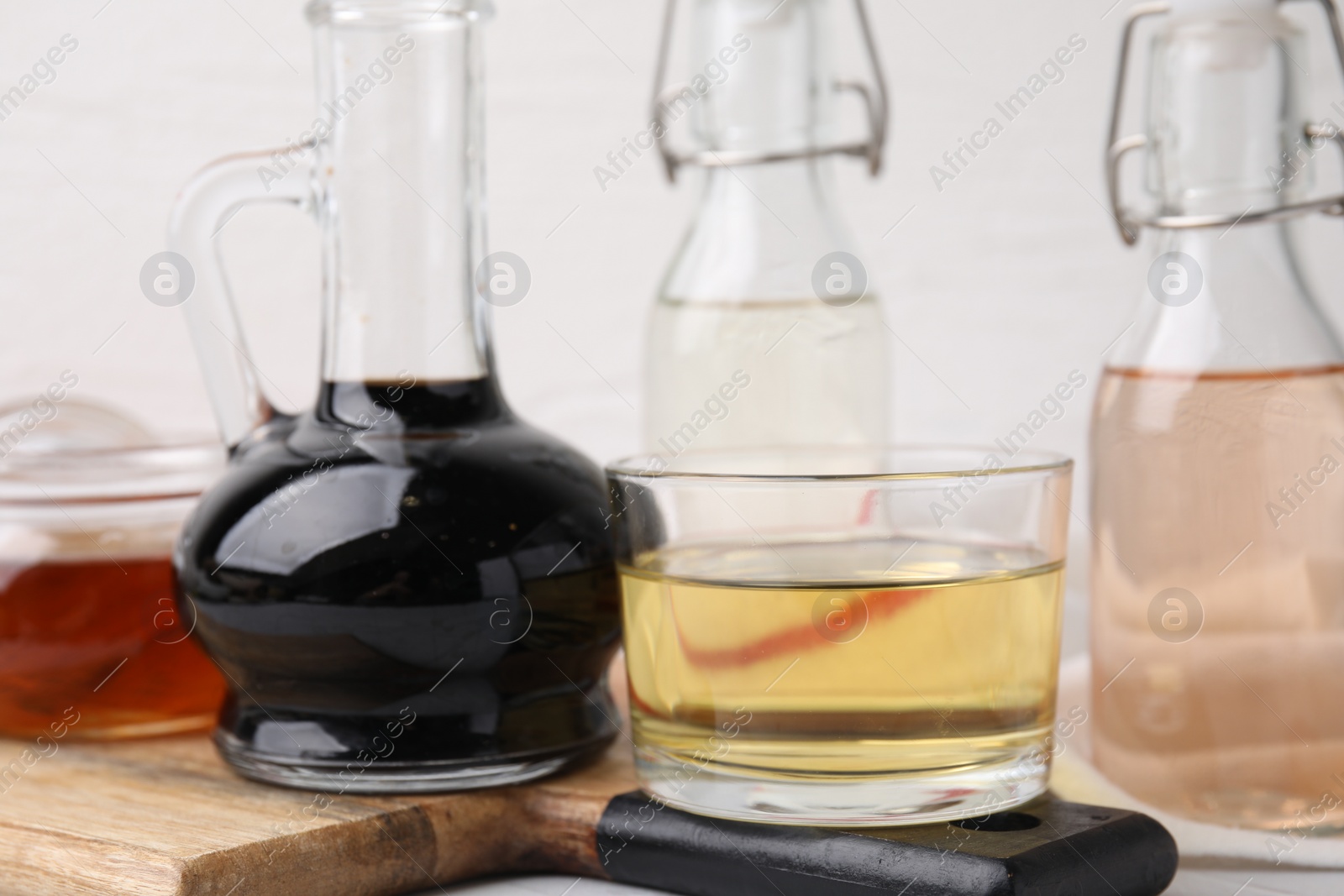 Photo of Many different types of vinegar on table