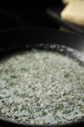 Photo of Melting butter in frying pan, closeup view