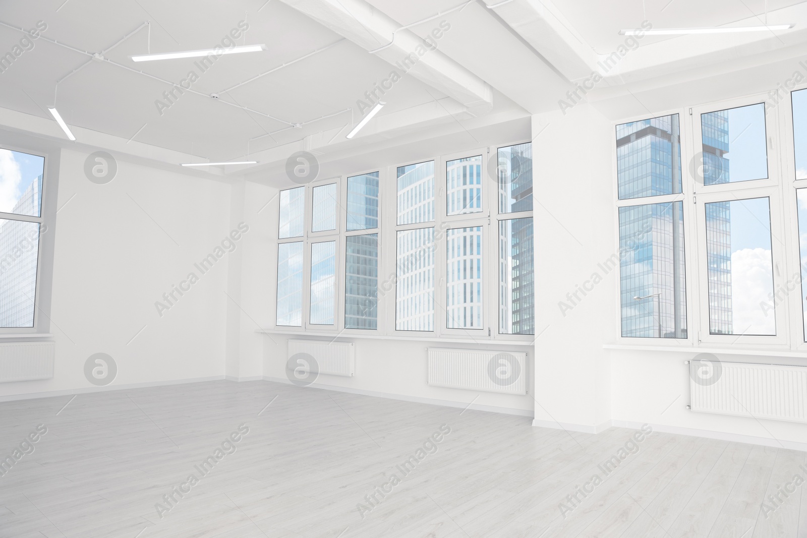 Photo of Modern office room with white walls and windows. Interior design