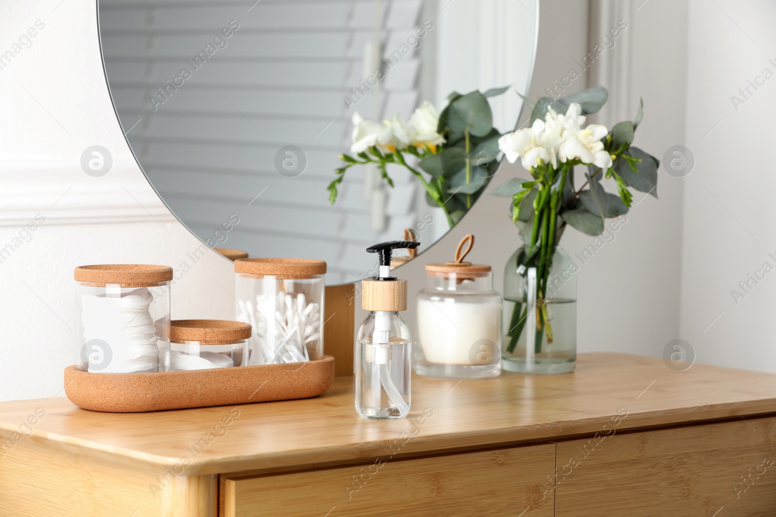 Photo of Bottle with dispenser cap on wooden table indoors