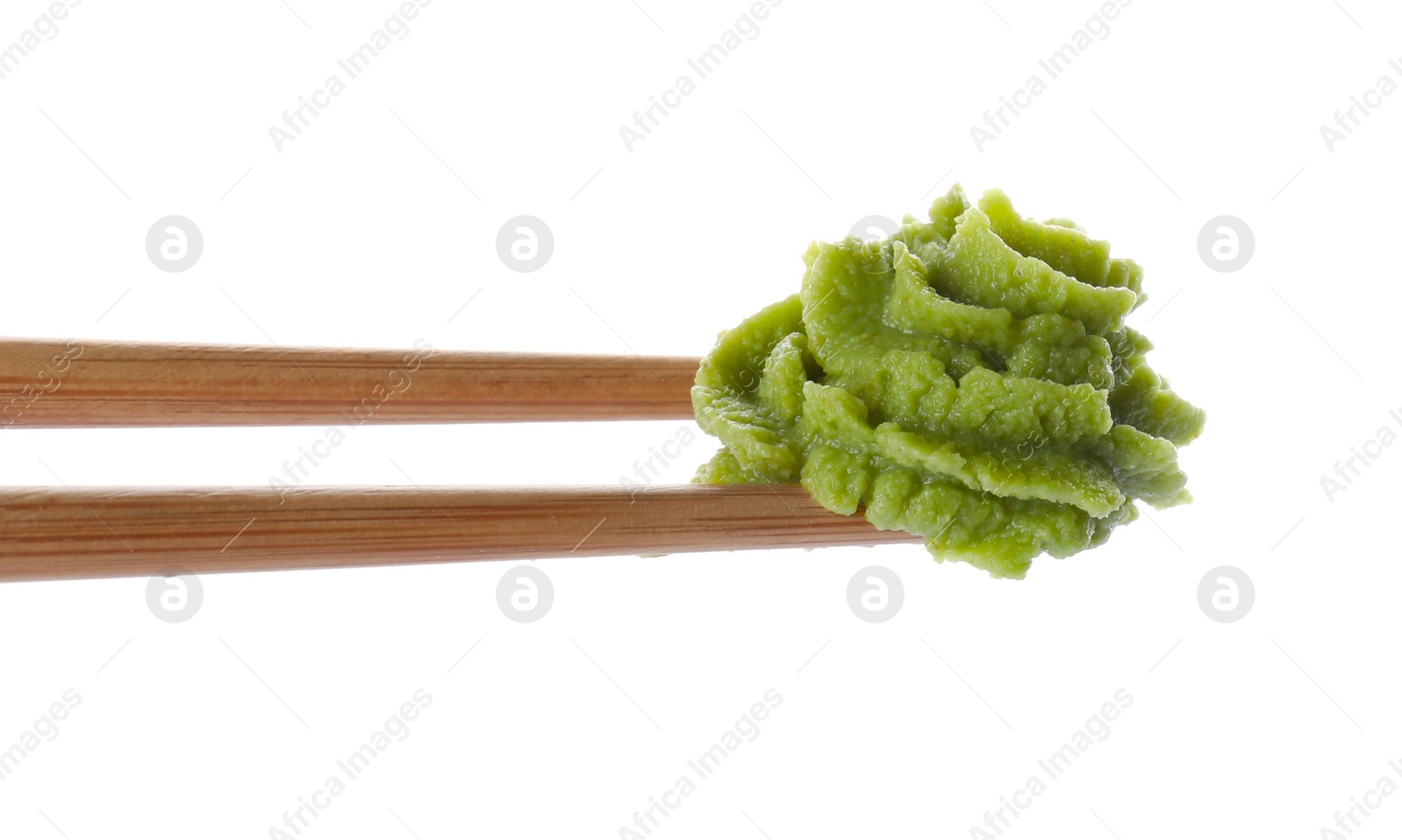 Photo of Chopsticks with swirl of wasabi paste isolated on white