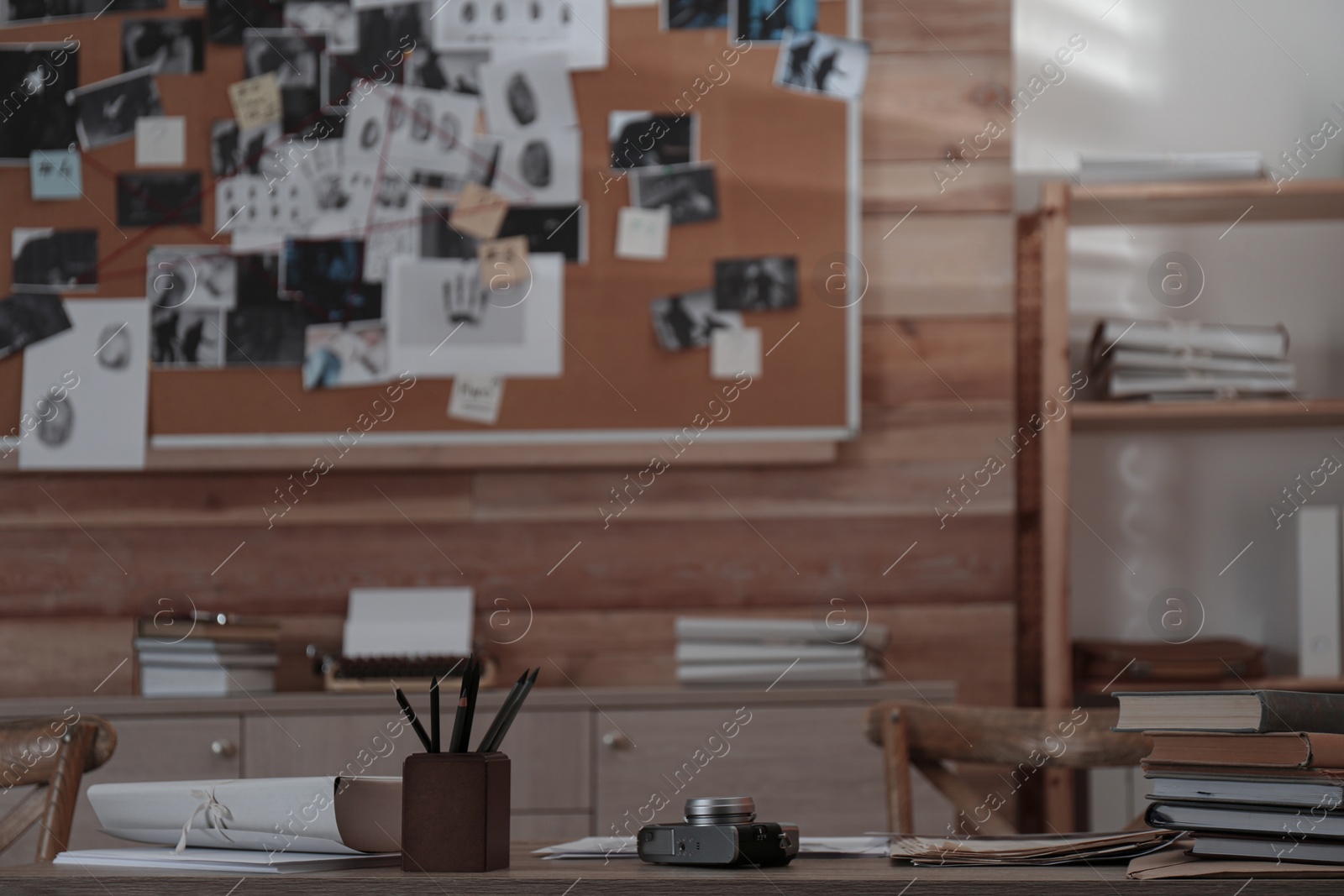 Photo of Detective's office interior with wooden desk and evidence board