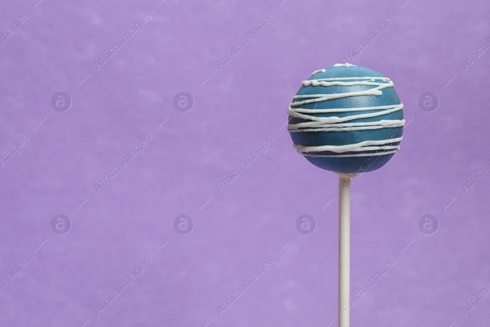 Photo of Bright delicious cake pop on color background. Space for text