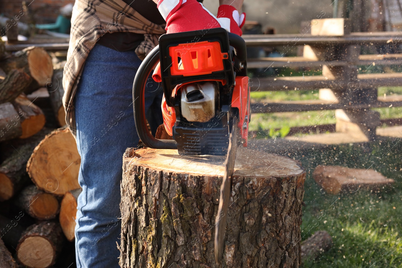 Photo of Man sawing wooden log on sunny day, closeup